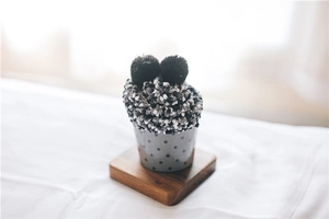Fluffy coral fleece socks presented as a cupcake in a polka dot paper cup gift box