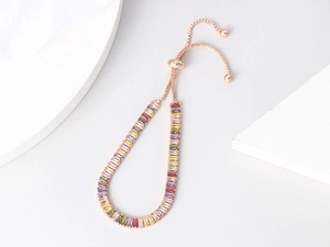 Detail of adjustable rose gold bracelet with colorful rectangular-cut zircon crystals