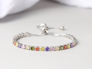 Macro view of adjustable tennis bracelet with colorful round zircons and sliding clasp