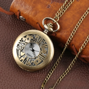 Macro detail of bronze Alice in Wonderland pocket watch with poker hollow pattern