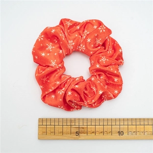 Red velvet Christmas hair scrunchie with white snowflake patterns and 10cm diameter