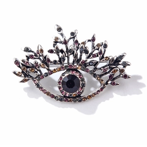 Macro detail of alloy evil eye brooch with multi-colored rhinestones and silver finish