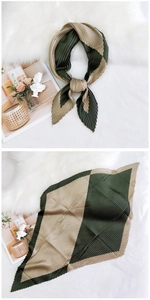 Detail of pleated paisley square scarf in dark green and khaki with accordion texture