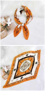 Detailed view of pleated silk scarf featuring equestrian horse prints in orange and cream