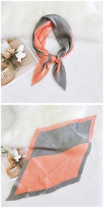 Detail of pleated silk-like scarf with orange-pink and gray color-block design
