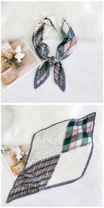 Detail of pleated silk scarf featuring colorful geometric patterns on faux fur background