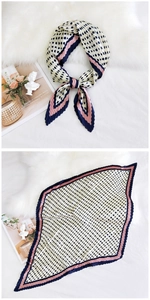 Close-up of pleated polka dot silk scarf in beige with pink and navy borders