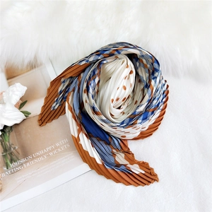 Pleated square silk scarf with paisley patterns in navy blue, brown, and white colors