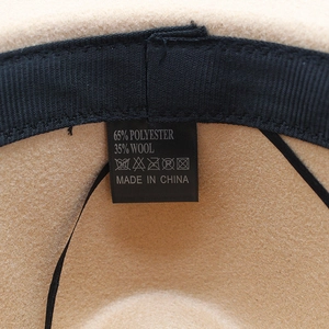 Detail of wool blend hat interior showing material tag and black grosgrain sweatband