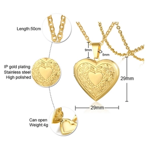 Macro detail of polished stainless steel heart locket with floral relief and open structure
