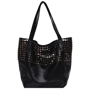 Large black studded tote bag for women with metallic rivets in a minimalist fashion style