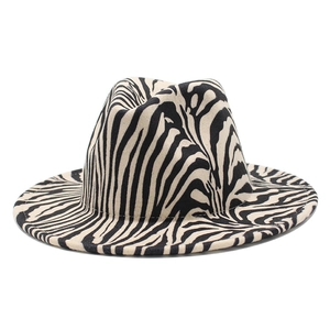 Detailed close-up of a wide-brimmed fedora hat featuring a bold black and white zebra pattern