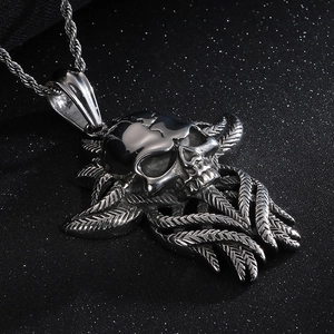 Macro shot of silver skull pendant with feather textures in gothic punk metal style