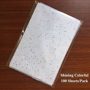 Macro shot of 100 sheets glitter colorful A5 tissue paper pack on wood background