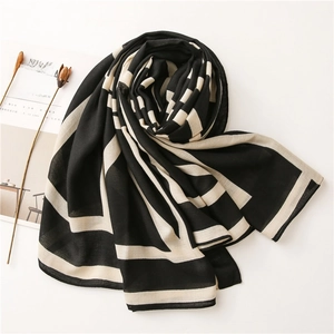 Close-up of black and white striped scarf on minimalist magazine background