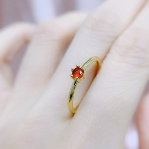 Minimalist six-prong gold plated ring with a round red gemstone for women