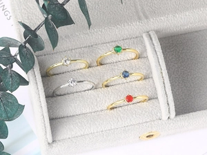 Exquisite solitaire gemstone rings in gold and silver plating displayed in velvet box