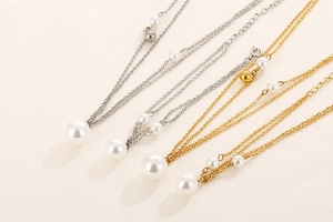 Detailed view of dual-layer stainless steel necklaces with pearls in gold and silver finish
