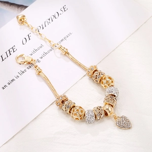 Golden DIY charm bracelet with heart pendant and mixed metallic beads on snake chain