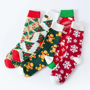 Set of four Christmas crew socks with gingerbread man, tree, and snowflake patterns