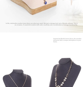 Close-up of velvet necklace display stands with wooden bases in light and dark grey tones