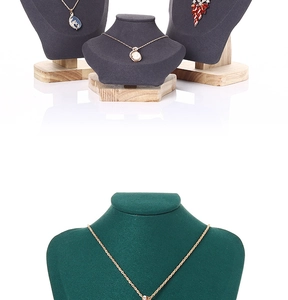 Detailed view of velvet necklace busts with premium wooden bases for jewelry display