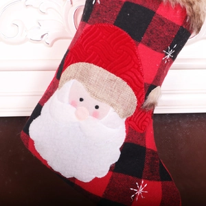 Detail of red and black buffalo plaid Christmas stocking with 3D Santa Claus applique