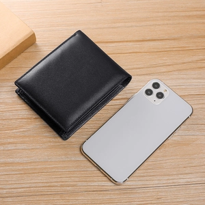 Men's trifold black leather wallet shown next to a smartphone for size reference