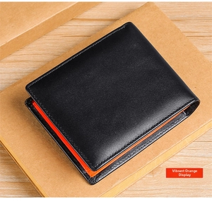 Detail of men's trifold leather wallet showing vibrant orange interior and black exterior