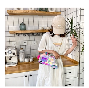 Detail of laser iridescent ice cream truck crossbody bag with metallic chain and pink pompom