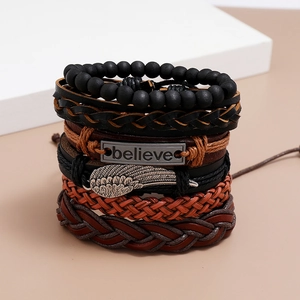 Close-up of multilayer leather bracelets with Believe plate and metal feather charm