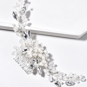 Silver bridal hair comb with elegant white pearls and sparkling leaf crystals
