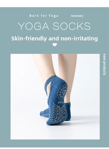 Detail of blue yoga socks featuring non-slip silicone grips and stylish cross straps