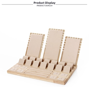 Bamboo and beige velvet jewelry display set for necklaces and rings on white background