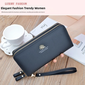Close-up of black lychee texture wallet with double zippers and gold clover emblem