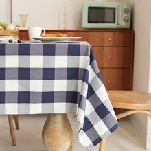 Detailed blue and white checkered cotton linen tablecloth with elegant fringe tassels