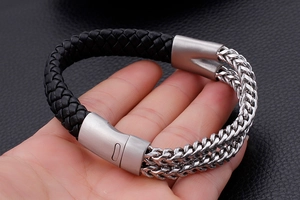 Detail of men's leather braided bracelet with double-row stainless steel chains and clasp