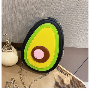Detail of avocado shaped crossbody bag with PU leather texture and gold chain strap