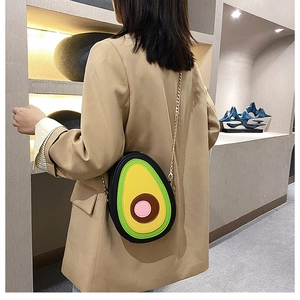 Close-up of avocado-shaped PU leather crossbody bag with elegant gold chain strap