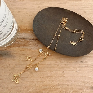 Detailed view of layered 925 silver gold butterfly necklace with pearl and zircon