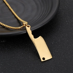 Detailed view of creative gold mini cleaver pendant on a punk style stainless steel necklace