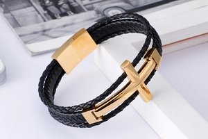 Detailed close-up of multilayer leather bracelet with golden cross and magnetic clasp