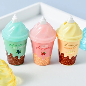 Three ice cream shaped magnetic bookmarks in mint, pink, and yellow colors set on a tray