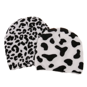 Two-piece winter knit beanies featuring black and white leopard and cow patterns