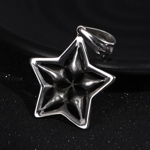 Macro detail of 316L stainless steel pentagram pendant with sparkling crystal accents