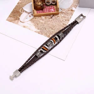 Detail of vintage multilayer braided leather bracelet with alloy beads and clasp