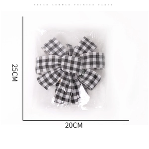 Detail view of black and white checkered bow ornament with 25cm by 20cm dimensions