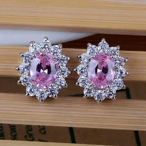 Macro detail of sunflower studs with pink oval zircon and sparkling white crystals