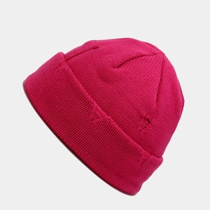 Detail shot of hot pink knit beanie with distressed hole design and ribbed texture