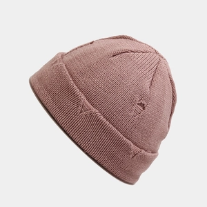 Detailed texture of dusty pink ribbed knit miki hat with distressed street style rips